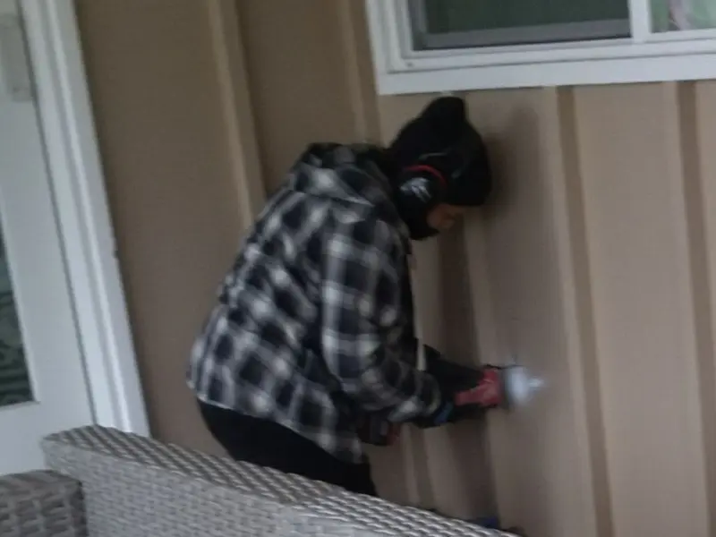 Professional electrician installing an exterior outlet in Enfield